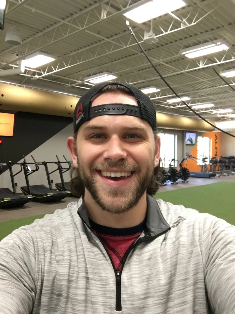 A man in a gym smiling for the camera.