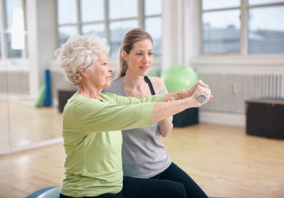 A woman and an older person are doing exercises.